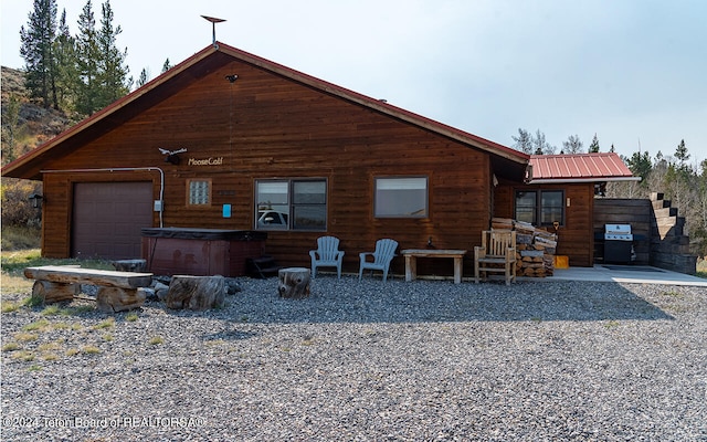 back of property with a garage