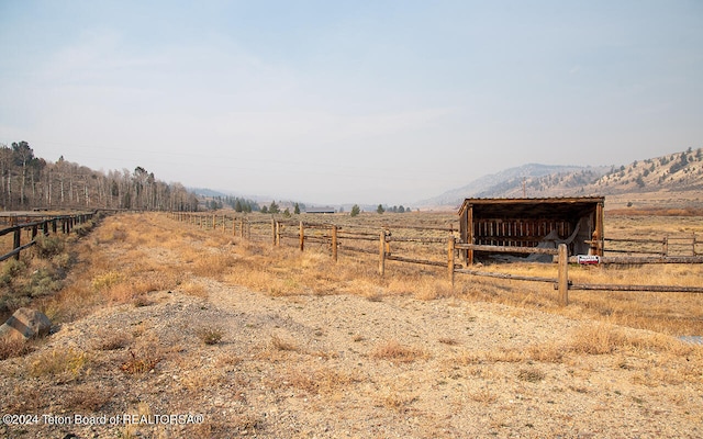 view of yard with a mountain view and a rural view