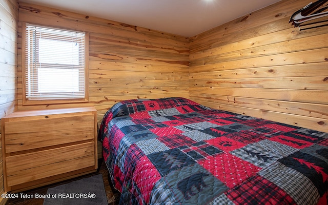 bedroom featuring wooden walls