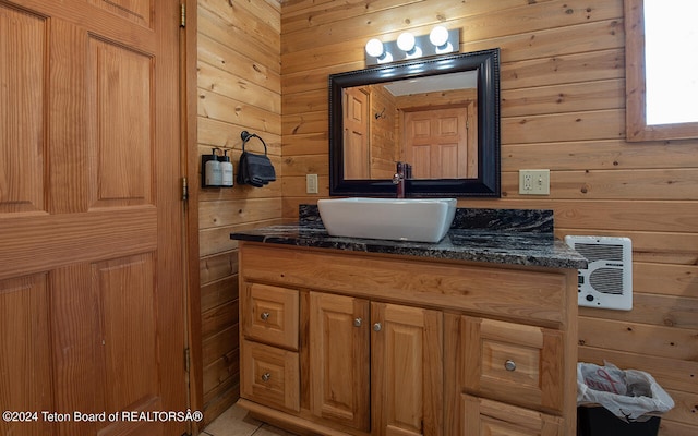 bathroom with wood walls, vanity, and heating unit