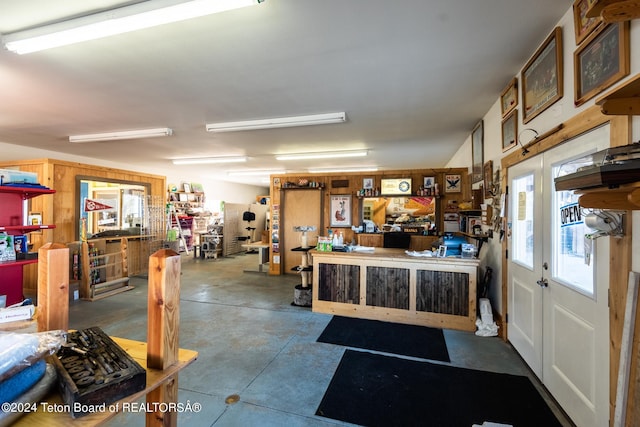 misc room featuring concrete flooring and a workshop area