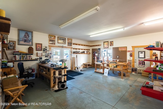 miscellaneous room featuring concrete flooring and a workshop area