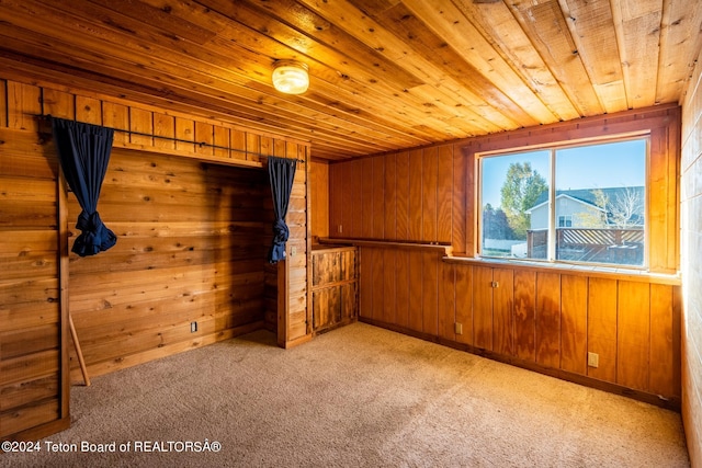 carpeted empty room with wood walls and wooden ceiling