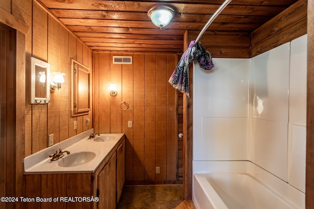 bathroom featuring vanity, wooden walls, shower / bath combo with shower curtain, and wooden ceiling