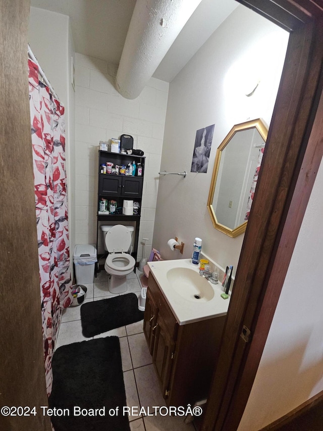 bathroom with vanity, toilet, curtained shower, and tile patterned flooring