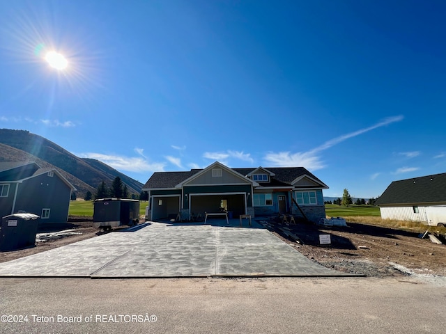 view of front of house with a mountain view and a patio area