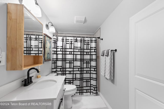 bathroom featuring vanity, toilet, and a shower with shower curtain