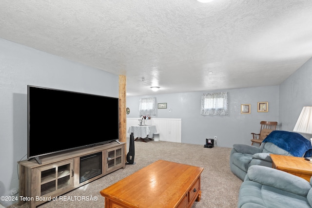 living room with light carpet and a textured ceiling