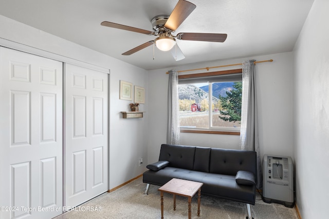 sitting room with light carpet and ceiling fan