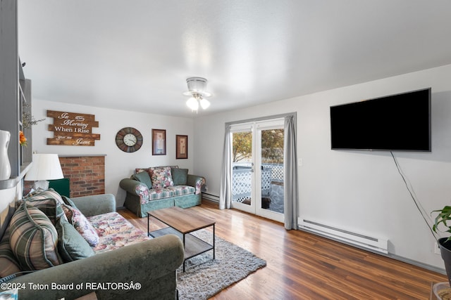 living room with ceiling fan, a baseboard radiator, and wood-type flooring