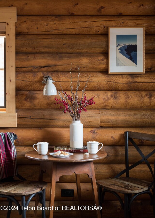 unfurnished dining area with log walls