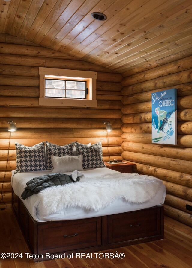 bedroom with lofted ceiling, rustic walls, dark hardwood / wood-style floors, and wooden ceiling