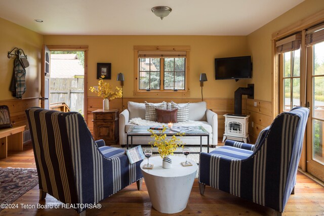 living room with hardwood / wood-style flooring and a wood stove