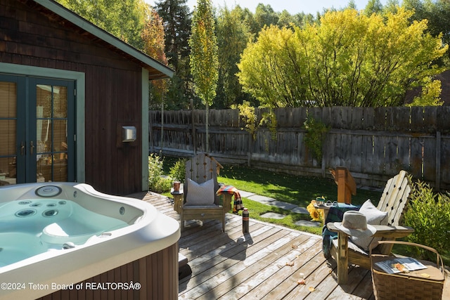 wooden terrace featuring a hot tub