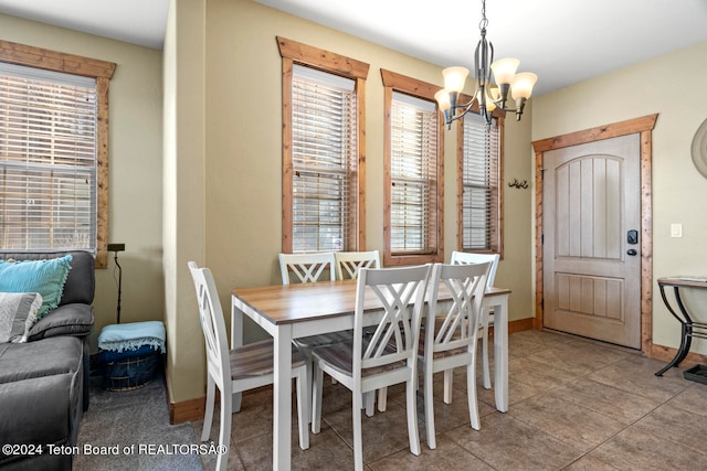 dining area featuring a chandelier and light tile patterned floors