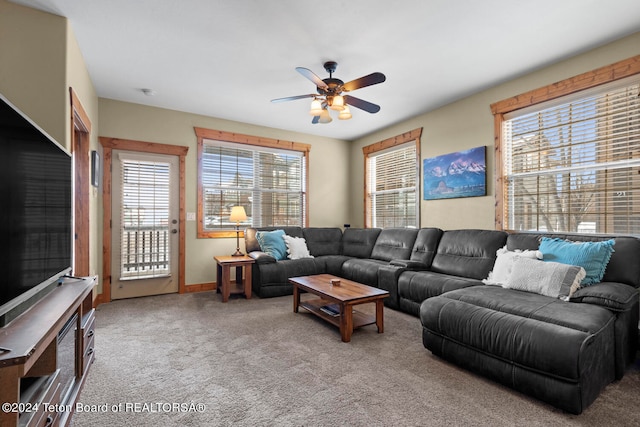 carpeted living room with ceiling fan