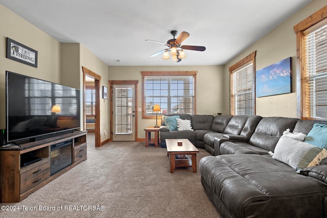 carpeted living room with ceiling fan and a wealth of natural light