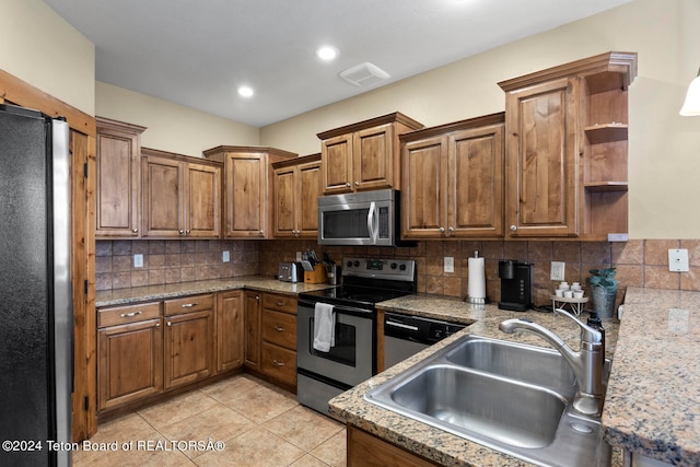 kitchen featuring sink, appliances with stainless steel finishes, light tile patterned flooring, and tasteful backsplash