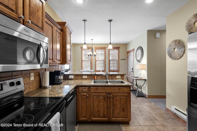 kitchen with a baseboard heating unit, stainless steel appliances, sink, light stone countertops, and light tile patterned floors