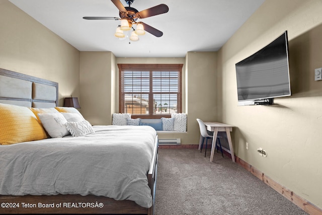 carpeted bedroom featuring a baseboard heating unit and ceiling fan