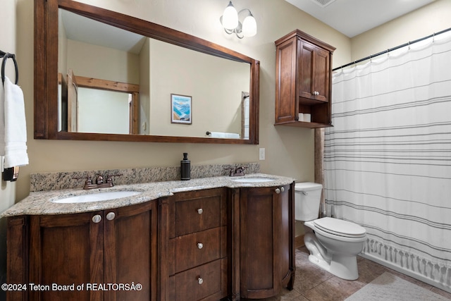 bathroom with walk in shower, vanity, toilet, and tile patterned flooring