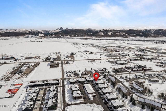 snowy aerial view with a mountain view