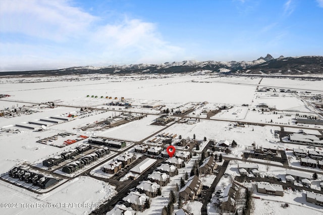 snowy aerial view with a mountain view