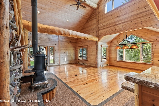 living room featuring light hardwood / wood-style flooring, wooden ceiling, wooden walls, and high vaulted ceiling