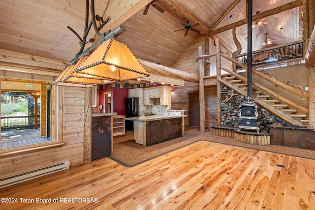 kitchen with a baseboard heating unit, wood ceiling, beam ceiling, light hardwood / wood-style flooring, and black refrigerator