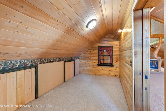 additional living space featuring wood walls, wooden ceiling, lofted ceiling, and light colored carpet