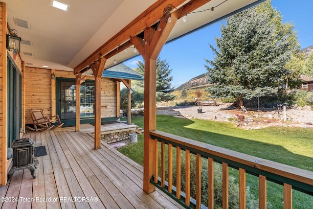 wooden terrace featuring a lawn