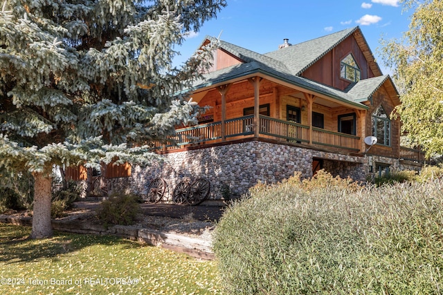 view of side of home with covered porch