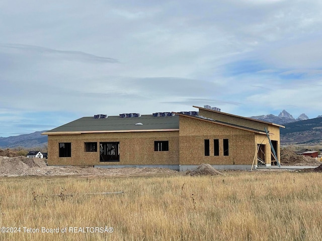 back of property with a mountain view