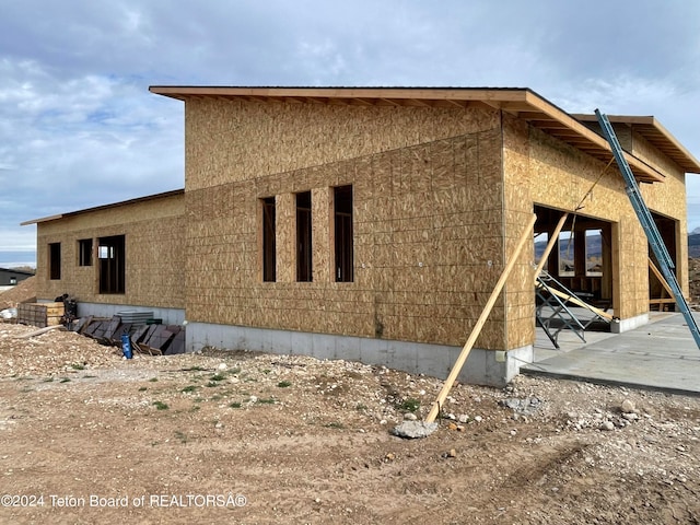 view of property exterior with a patio area