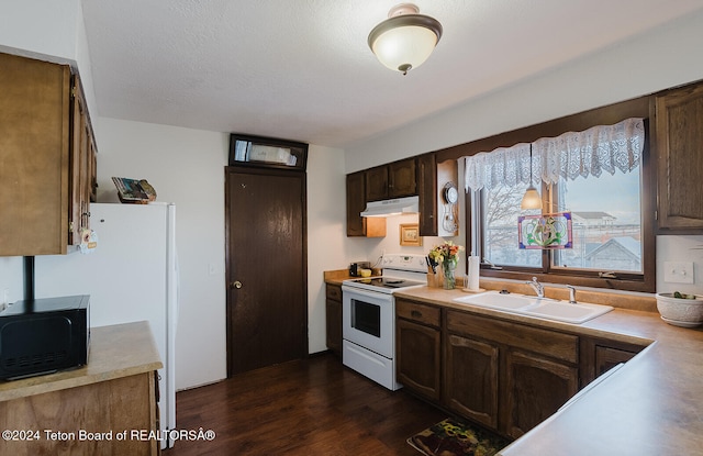 kitchen with a textured ceiling, dark wood-type flooring, white range with electric stovetop, dark brown cabinetry, and sink