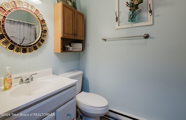 bathroom with vanity, toilet, and a baseboard radiator