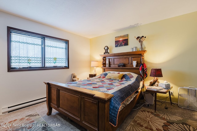 bedroom with light carpet and baseboard heating