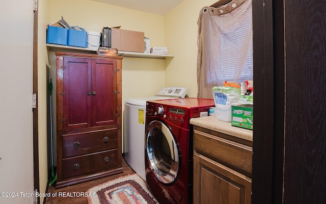 laundry room with cabinets, independent washer and dryer, and hardwood / wood-style flooring