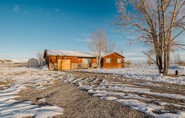 view of front of house featuring a shed