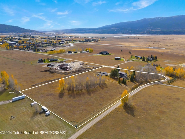 drone / aerial view featuring a rural view and a mountain view