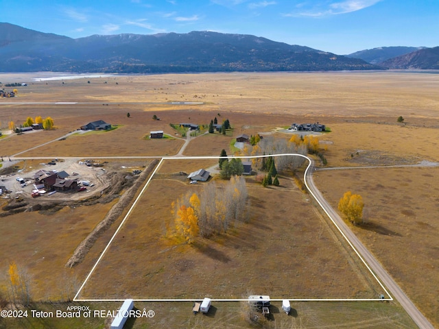 drone / aerial view featuring a mountain view and a rural view