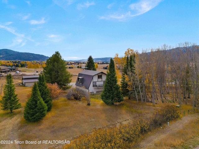 birds eye view of property featuring a mountain view and a rural view