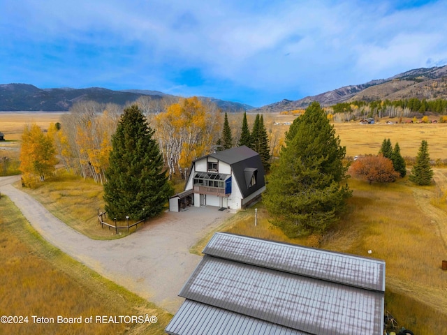 drone / aerial view featuring a rural view and a mountain view