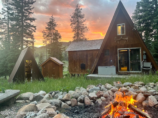 back house at dusk with an outbuilding