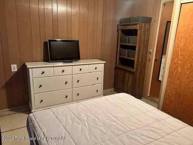 bedroom with wooden walls