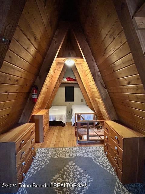 bonus room with light hardwood / wood-style floors, wood ceiling, and vaulted ceiling