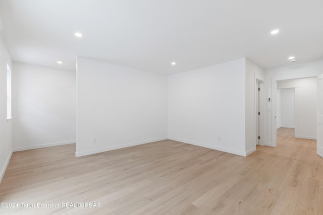 empty room with light hardwood / wood-style flooring