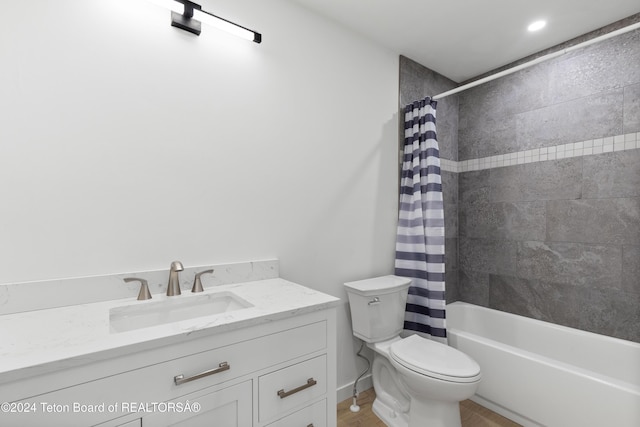 full bathroom featuring shower / bath combination with curtain, vanity, and toilet