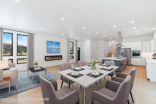 dining space with light hardwood / wood-style floors