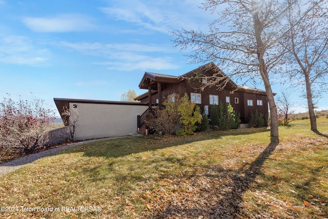 view of property exterior featuring a lawn